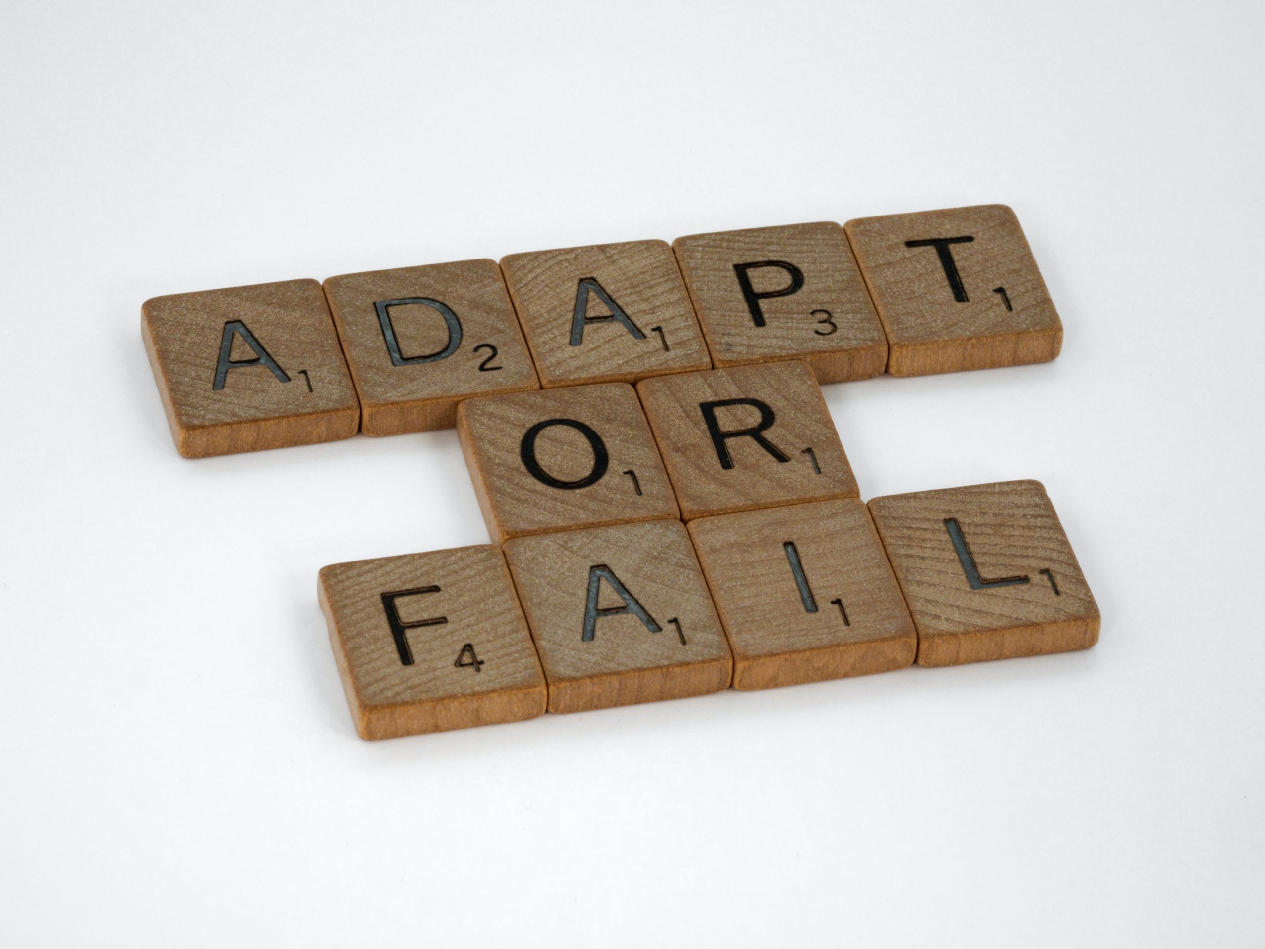 Image of scrabble letters spelling adapt or fail