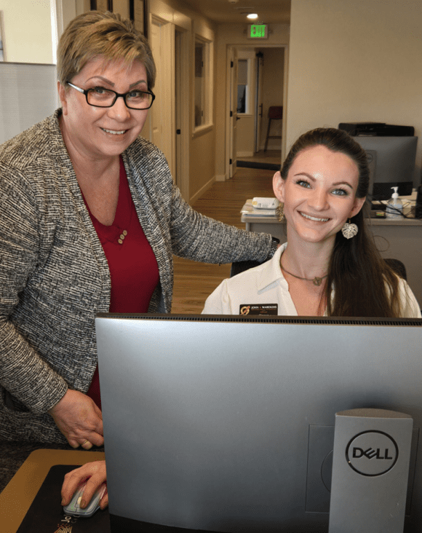 two women at the john warekois front desk