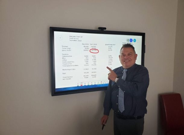 Image of John Warekois In Front of A Smart Board