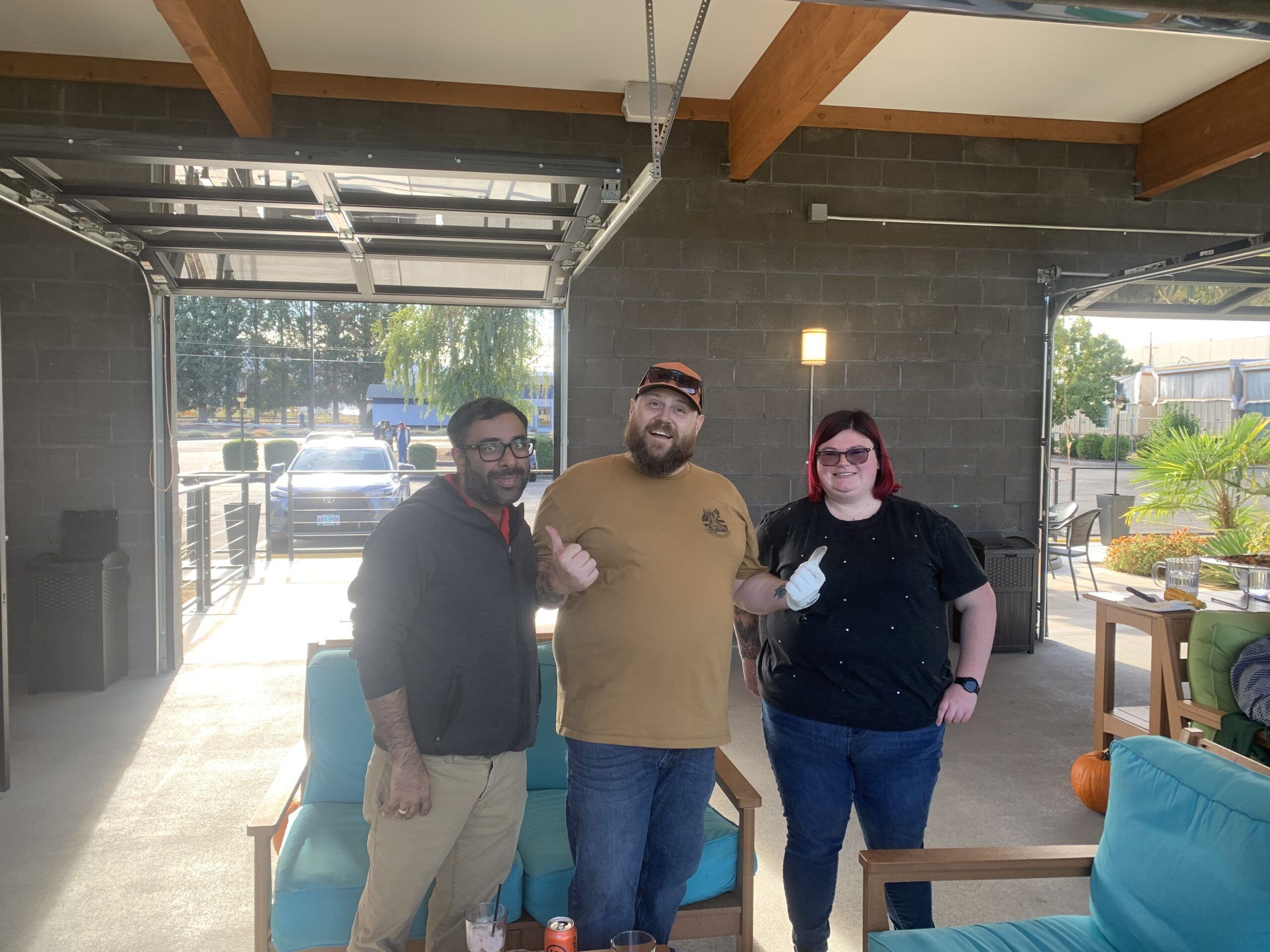 Three team members standing together at the top golf team event