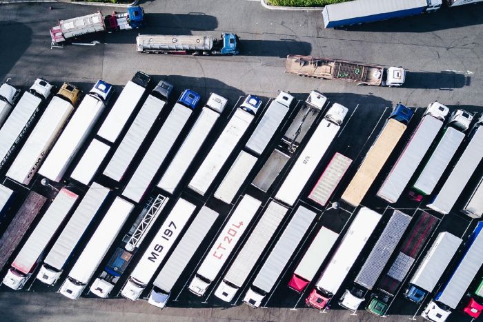 Image of a parking lot of semi trucks.
