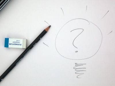 Image of piece of paper with eraser, pencil, & question mark drawing