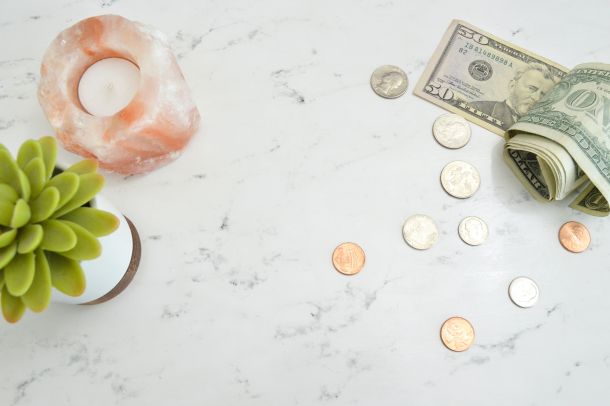 Granite countertop with plant, candle, and money on top