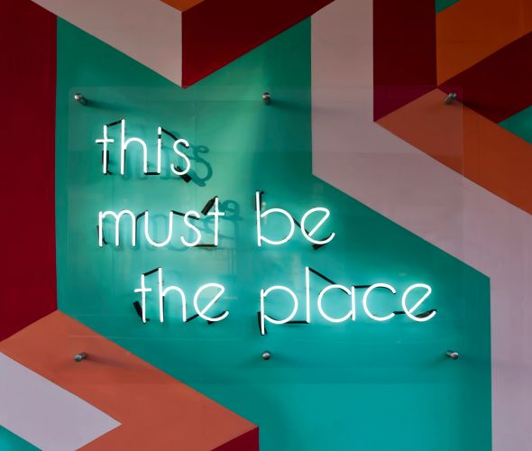 Neon sign that reads "this must be the place"