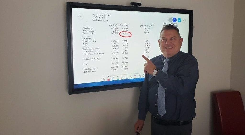 Image of John Warekois in front of smart board