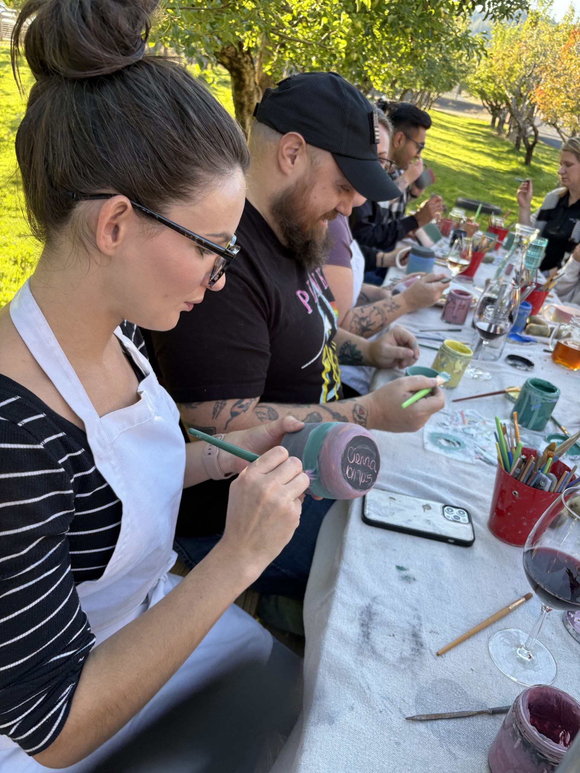 John Warekois Team sitting at picnic table making mugs